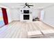 Bright and open living room featuring a modern fireplace, ceiling fan, and access to the patio at 2101 Oriole Ln, South Daytona, FL 32119