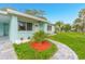 Landscaped front yard with a paved walkway leading to the entrance at 211 Maurice Ave, New Smyrna Beach, FL 32168