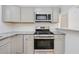 Modern kitchen with stainless steel appliances and gray cabinets at 211 Maurice Ave, New Smyrna Beach, FL 32168