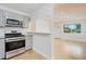 Modern kitchen features stainless steel appliances and granite countertops at 211 Maurice Ave, New Smyrna Beach, FL 32168