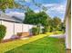 Landscaped backyard with patio and built-in grill at 216 Fairgreen Ave, New Smyrna Beach, FL 32168