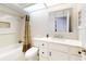 Clean bathroom with white vanity, bathtub, and shower at 216 Fairgreen Ave, New Smyrna Beach, FL 32168