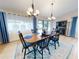 Formal dining room with wooden table, blue chairs, and hardwood floors at 216 Fairgreen Ave, New Smyrna Beach, FL 32168