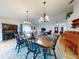 Open dining room with wooden table and chairs, view into living room at 216 Fairgreen Ave, New Smyrna Beach, FL 32168