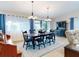 Formal dining room with wooden table, blue chairs, and hardwood floors at 216 Fairgreen Ave, New Smyrna Beach, FL 32168