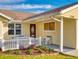 Front porch with white railing and seating area at 216 Fairgreen Ave, New Smyrna Beach, FL 32168