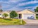 Front view of a yellow house with garage at 216 Fairgreen Ave, New Smyrna Beach, FL 32168