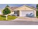 Front view of a yellow house with garage at 216 Fairgreen Ave, New Smyrna Beach, FL 32168