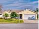 Yellow house with a two-car garage at 216 Fairgreen Ave, New Smyrna Beach, FL 32168