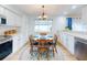 Eat-in kitchen with white cabinets and wood table at 216 Fairgreen Ave, New Smyrna Beach, FL 32168