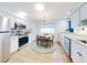 Bright kitchen with stainless steel appliances and white cabinets at 216 Fairgreen Ave, New Smyrna Beach, FL 32168