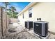 Two new central AC units located in the backyard at 221 Columbus Ave, New Smyrna Beach, FL 32169