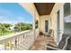 Relaxing balcony overlooking tree-lined street at 221 Columbus Ave, New Smyrna Beach, FL 32169