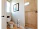 Bathroom with toilet, shower, and a patterned seat at 221 Columbus Ave, New Smyrna Beach, FL 32169