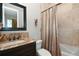 Bathroom boasts granite countertop and bathtub at 221 Columbus Ave, New Smyrna Beach, FL 32169