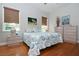 Bright bedroom with hardwood floors and coastal decor at 221 Columbus Ave, New Smyrna Beach, FL 32169