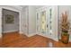 Bright entryway with hardwood floors and an elegant front door at 221 Columbus Ave, New Smyrna Beach, FL 32169