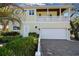 Two-story house with white garage door and balcony at 221 Columbus Ave, New Smyrna Beach, FL 32169