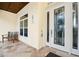 White front door with a glass insert and a tiled entryway at 221 Columbus Ave, New Smyrna Beach, FL 32169