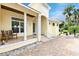 Front porch with white columns and a rustic bench at 221 Columbus Ave, New Smyrna Beach, FL 32169