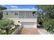 Two-story house with a metal roof and a garage at 221 Columbus Ave, New Smyrna Beach, FL 32169