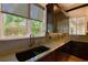 Kitchen sink with granite countertop and a view of the backyard at 221 Columbus Ave, New Smyrna Beach, FL 32169