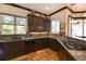 Modern kitchen with dark wood cabinets and granite countertops at 221 Columbus Ave, New Smyrna Beach, FL 32169