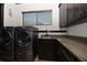 Laundry room with modern appliances and granite countertop at 221 Columbus Ave, New Smyrna Beach, FL 32169