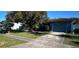 House with a large tree and a spacious front yard at 2233 Austin Ave, Deltona, FL 32738