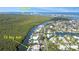 Aerial view showcasing waterfront property, canal access, and neighborhood at 236 Quay Assisi, New Smyrna Beach, FL 32169