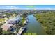 Aerial view of waterfront home with private dock and pool; lush landscaping at 236 Quay Assisi, New Smyrna Beach, FL 32169