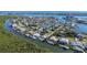 Wide aerial showcasing waterfront community, homes, and lush landscape at 236 Quay Assisi, New Smyrna Beach, FL 32169