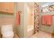 Bathroom with toilet, shower/tub combo, and coral-colored towels at 236 Quay Assisi, New Smyrna Beach, FL 32169