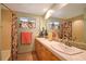 Bathroom with double vanity, floral shower curtain, and tiled floors at 236 Quay Assisi, New Smyrna Beach, FL 32169