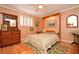 Guest bedroom with a wall bed, hardwood floors, and antique dresser at 236 Quay Assisi, New Smyrna Beach, FL 32169