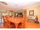 Bright dining room with hardwood floors and large wooden table with seating at 236 Quay Assisi, New Smyrna Beach, FL 32169