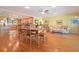 Open dining area with hardwood floors, a large table, and adjacent kitchen view at 236 Quay Assisi, New Smyrna Beach, FL 32169