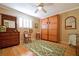 Guest bedroom with hardwood floors, built-in wardrobe, and antique furniture at 236 Quay Assisi, New Smyrna Beach, FL 32169