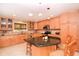 Spacious kitchen featuring granite island, light wood cabinetry, and breakfast bar at 236 Quay Assisi, New Smyrna Beach, FL 32169