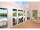 Bright living room with large windows, pool access, and canal views at 236 Quay Assisi, New Smyrna Beach, FL 32169