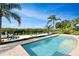 Relaxing pool area with brick pavers, lush landscaping and canal views at 236 Quay Assisi, New Smyrna Beach, FL 32169