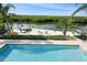 Inviting pool and private dock with boat lift overlooking the tranquil waterway at 236 Quay Assisi, New Smyrna Beach, FL 32169