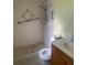 Bathroom featuring a walk-in shower with handrails, toilet, and vanity at 2408 Victory Palm Dr, Edgewater, FL 32141