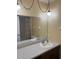 Bathroom with vanity, large mirror and modern hanging lights at 2408 Victory Palm Dr, Edgewater, FL 32141
