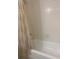 Functional bathroom featuring a shower and tub combination with neutral-colored tile at 2408 Victory Palm Dr, Edgewater, FL 32141