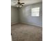 This bedroom has neutral paint, carpet and a ceiling fan with lighting at 2408 Victory Palm Dr, Edgewater, FL 32141