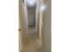 Clean hallway featuring tile flooring, a closet, and access to the bathroom, ensuring functionality at 2408 Victory Palm Dr, Edgewater, FL 32141