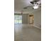 Bright living room with tile flooring, ceiling fans, and sliding glass doors to the outside at 2408 Victory Palm Dr, Edgewater, FL 32141