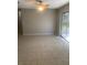 Sunlit living room with tile flooring, ceiling fan, and sliding glass doors to outdoor space at 2408 Victory Palm Dr, Edgewater, FL 32141
