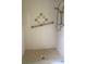 Shower with safety rail, shower head, and decorative tile at 2408 Victory Palm Dr, Edgewater, FL 32141